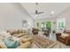 Spacious living room with vaulted ceilings, comfortable seating, ceiling fan, and sliding glass doors to the patio at 2020 Willow Run Dr. # D, Little River, SC 29566
