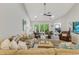 Open living room with vaulted ceilings, comfortable seating, ceiling fan, and sliding glass doors to the outdoor patio at 2020 Willow Run Dr. # D, Little River, SC 29566