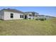 Expansive backyard featuring a white fence, well-maintained lawn, and a covered patio area at 212 Carolina Lakes Blvd., Myrtle Beach, SC 29588