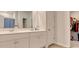 Bathroom featuring double sinks, a large mirror, and a walk-in closet at 212 Carolina Lakes Blvd., Myrtle Beach, SC 29588