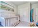 Bedroom featuring a white crib, closet, and art work hanging on the walls at 212 Carolina Lakes Blvd., Myrtle Beach, SC 29588