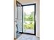 View from the doorway of a house, leading to a lush green yard and garden at 212 Carolina Lakes Blvd., Myrtle Beach, SC 29588