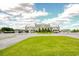 Grassy lawn and circular driveway leading up to a large building with manicured landscaping at 212 Carolina Lakes Blvd., Myrtle Beach, SC 29588