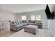 Cozy living room features a large sectional sofa, plush ottoman, and light wood-look flooring at 212 Carolina Lakes Blvd., Myrtle Beach, SC 29588