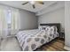 Bedroom features a ceiling fan, a window with sheer curtains, and a plush queen-sized bed at 2265 Huntingdon Dr. # J, Surfside Beach, SC 29575