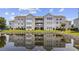 Beautiful exterior of this condominium community reflected in a well maintained lake at 2265 Huntingdon Dr. # J, Surfside Beach, SC 29575