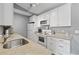 Well-lit kitchen with white cabinets, stainless steel appliances, granite countertops at 2265 Huntingdon Dr. # J, Surfside Beach, SC 29575