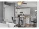 Open kitchen has white cabinets, stainless appliances, island bar and dining area at 2265 Huntingdon Dr. # J, Surfside Beach, SC 29575