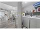 Convenient laundry room with washer, dryer, and shelving for organized storage solutions at 2265 Huntingdon Dr. # J, Surfside Beach, SC 29575
