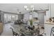 Open-concept living room and kitchen with grey walls and stylish round dining table at 2265 Huntingdon Dr. # J, Surfside Beach, SC 29575