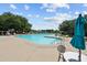 A well-maintained community pool with clear blue water, surrounded by ample seating and lush landscaping for relaxation at 2265 Huntingdon Dr. # J, Surfside Beach, SC 29575