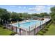A community pool with a clear blue water, surrounded by ample seating and lush landscaping for relaxation at 2265 Huntingdon Dr. # J, Surfside Beach, SC 29575