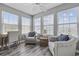 Bright sunroom with three windows, ceiling fan, wood floors and comfortable armchairs at 2265 Huntingdon Dr. # J, Surfside Beach, SC 29575