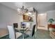 Cozy dining area with a glass table, chandelier, and convenient access to the kitchen at 2309 Withers Dr. # 5, Myrtle Beach, SC 29577