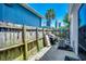 Fenced backyard with a palm tree, grill and air conditioning condenser at 2309 Withers Dr. # 7, Myrtle Beach, SC 29577