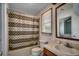 Bathroom features a shower with curtains, toilet, and sink with a wooden vanity at 2309 Withers Dr. # 7, Myrtle Beach, SC 29577