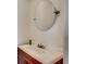 Bathroom vanity with a white sink and round mirror with antique fixtures at 2309 Withers Dr. # 7, Myrtle Beach, SC 29577