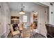 Dining area features a modern light fixture, a round glass table, and wicker chairs at 2309 Withers Dr. # 7, Myrtle Beach, SC 29577