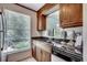 The kitchen features a window that looks out to the garden, with brown cabinets at 2309 Withers Dr. # 7, Myrtle Beach, SC 29577