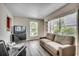 Comfortable living room with large windows, gray flooring, and a neutral sofa at 2309 Withers Dr. # 7, Myrtle Beach, SC 29577