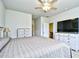 Bedroom features a ceiling fan, television, and white dressers, combining comfort and functionality at 2315 Blackthorn Dr., Conway, SC 29526