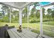 Inviting screened porch with views of the fenced backyard and surrounding trees at 2315 Blackthorn Dr., Conway, SC 29526