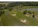 Overhead view of a well-maintained golf course with manicured greens, sand traps, and scenic water features at 2318 Via Palma Dr., North Myrtle Beach, SC 29582