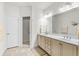 Bright bathroom features double sink vanity, large mirror, tile flooring, and a glass-enclosed shower stall at 2318 Via Palma Dr., North Myrtle Beach, SC 29582
