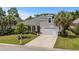 Beautiful home featuring a meticulously landscaped front yard, a two-car garage, and elegant architectural details at 2318 Via Palma Dr., North Myrtle Beach, SC 29582