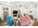 Inviting living room featuring a marble fireplace, hardwood floors, and comfortable seating arrangement under ceiling fans at 2318 Via Palma Dr., North Myrtle Beach, SC 29582