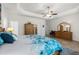 Comfortable main bedroom featuring a tray ceiling, ceiling fan, natural light, and coordinated furniture at 2318 Via Palma Dr., North Myrtle Beach, SC 29582
