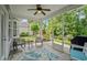 Comfortable screened porch with ceiling fan and tiled floor overlooks the manicured lawn and garden at 2318 Via Palma Dr., North Myrtle Beach, SC 29582