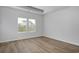 Bright bedroom features wood-look flooring and two windows offering views of the neighborhood at 245 Nw Mayflower Dr., Calabash, NC 28467