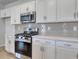 Gourmet kitchen with stainless appliances, gas range, and modern tile backsplash at 245 Nw Mayflower Dr., Calabash, NC 28467