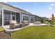 This backyard features a stone patio, a cozy firepit, and lush green landscaping, perfect for entertaining at 2572 Brescia St., Myrtle Beach, SC 29579