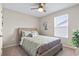 A cozy bedroom features a wicker-style bed, decorative pillows, and natural light from a window at 2572 Brescia St., Myrtle Beach, SC 29579
