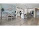 Open dining and kitchen featuring coastal blue accent wall, stainless appliances, and seating at 2572 Brescia St., Myrtle Beach, SC 29579