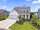 Charming home featuring a two-car garage, manicured lawn, and delightful landscaping at 2572 Brescia St., Myrtle Beach, SC 29579