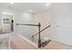 Upstairs hallway with a staircase featuring white banisters and views into adjacent bedrooms at 2572 Brescia St., Myrtle Beach, SC 29579