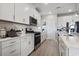 Bright kitchen featuring white cabinets, stainless steel appliances, and a stylish subway tile backsplash at 2572 Brescia St., Myrtle Beach, SC 29579