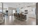 Open-concept kitchen boasts white cabinets, stainless appliances, and a large island with seating for four at 2572 Brescia St., Myrtle Beach, SC 29579