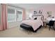 Stylish bedroom with a pink color scheme, a comfortable bed, and ample natural light at 2606 Tranquility Loop, Longs, SC 29568