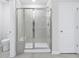 New bathroom featuring glass shower with built-in bench, with a white door and toilet nearby at 2610 Tranquility Loop, Longs, SC 29568