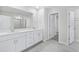 Bright bathroom boasts double sinks with a large mirror and a view into the walk-in shower at 2610 Tranquility Loop, Longs, SC 29568