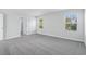 Spacious bedroom with carpet, two windows, and view to attached bath at 2610 Tranquility Loop, Longs, SC 29568