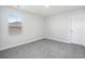 New bedroom with neutral carpet, window with blinds for light control, and a door for entry at 2610 Tranquility Loop, Longs, SC 29568