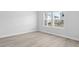 Bright bedroom with durable floors, two windows with blinds, neutral paint and ample space at 2610 Tranquility Loop, Longs, SC 29568