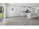 Open floorplan view of the living room flowing into the kitchen and sliding glass doors to back yard at 2610 Tranquility Loop, Longs, SC 29568
