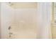 Bathroom showcasing a tub and shower with a white curtain, white tile walls, and window to the side at 264 La Patos Dr., Myrtle Beach, SC 29588