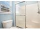Bathroom showcasing a glass door shower, toilet and window with blinds for natural lighting at 264 La Patos Dr., Myrtle Beach, SC 29588